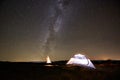 Tourist camping in the mountains under night starry sky Royalty Free Stock Photo