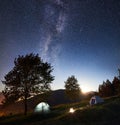 Tourist camping and tent under night sky full of stars Royalty Free Stock Photo