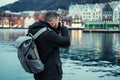 Tourist with camrea against Tyskebryggen in Bergen, Norway