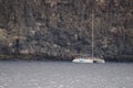 Tourist catamaran next to a cliff.