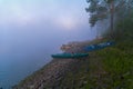 Tourist catamarans on the river bank in the morning mist