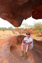 Tourist in a cave in Ayers Rock (Unesco),Australia Royalty Free Stock Photo