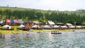 Tourist center in Turt Khankh village in Mongolia on the shore of Lake Hovsgol with a Mongolian flag on the roof .
