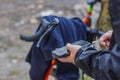 A tourist charges a smartphone with a power bank on the background of a bicycle in nature