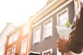 Tourist in city sightseeing. Hand holding map with old buildings Royalty Free Stock Photo