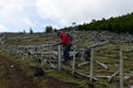 Tourist climbs over the fence in Tierra del Fuego.