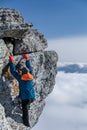 Tourist climbs the rock