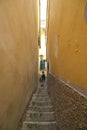 Tourist climbs a steep staircase in a narrow alley in the center of the village