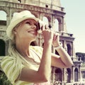 Tourist and Coliseum, Rome. Cheerful Blonde Woman with Camera Royalty Free Stock Photo