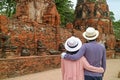 Tourist Couple Admiring a Group of Headless Buddha Images Remains in Wat Mahathat Ancient Temple in Ayutthaya, Thailand