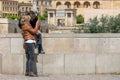 Tourist couple in Cordoba in front of the Bridge`s Gate and the Mosque