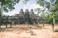 Tourist couple cycling around Angkor temple, Cambodia. Ta Keo building ruins in the jungle. Eco friendly tourism traveling Royalty Free Stock Photo