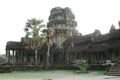 Tourist couple cycling around Angkor temple, Cambodia. Ta Keo building ruins in the jungle. Royalty Free Stock Photo