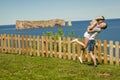 Tourist couple enjoying Perce Rock view from Gaspe in Quebec