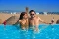 Tourist couple having bath in infinity pool Royalty Free Stock Photo