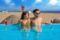 Tourist couple having bath in infinity pool Royalty Free Stock Photo