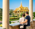 Tourist couple in Phnom Penh, Cambodia. Tourism in Royal Palace. Travel in Asia. Woman and man visiting landmark. City vacation.