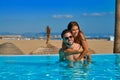 Tourist couple piggyback in infinity pool Royalty Free Stock Photo