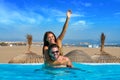Tourist couple piggyback in infinity pool Royalty Free Stock Photo