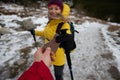 Tourist couple sharing with delicious chocolate snack bar on the winter trail Royalty Free Stock Photo