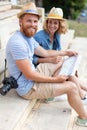 tourist couple sitting on steps looking at city map Royalty Free Stock Photo