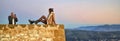 Tourist couple taking photo on the precipice of Caravaca`s castle in Spain. Royalty Free Stock Photo