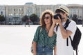 Tourist couple taking photos on camera on street Royalty Free Stock Photo