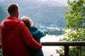 Tourist couple watching and pointing at a church on the small island in the middle of the Bled lake, Slovenia Royalty Free Stock Photo