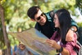 Tourist couples are happily looking at maps to find their destination