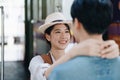 Tourist couples showing their love and happiness in a sweet way while waiting for their journey at the train station.