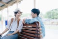 Tourist couples showing their love and happiness in a sweet way while waiting for their journey at the train station.