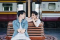 Tourist couples showing their love and happiness in a sweet way while waiting for their journey at the train station.