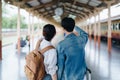 Tourist couples showing their love and happiness in a sweet way while waiting for their journey at the train station.