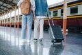 Tourist couples showing their love and happiness in a sweet way while waiting for their journey at the train station.