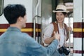 Tourist couples showing their love and happiness in a sweet way while waiting for their journey at the train station.