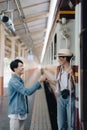 Tourist couples showing their love and happiness in a sweet way while waiting for their journey at the train station.