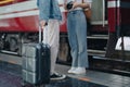 Tourist couples showing their love and happiness in a sweet way while waiting for their journey at the train station.