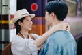 Tourist couples showing their love and happiness in a sweet way while waiting for their journey at the train station.