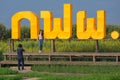 Tourist couples taking selfies at sunflower field