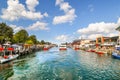 A tourist cruise boat on the Alter Strom canal in the popular cruise port fishing village of Warnemunde Germany on the Baltic Sea. Royalty Free Stock Photo