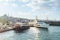 Tourist Cruise ship parking at the Eminonu Pier in the bosphorus strait, Istanbul, Turkey with background of the Suleymaniye