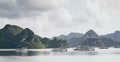 Tourist cruise ships sailing among limestone mountains in Halong Bay, Vietnam Royalty Free Stock Photo