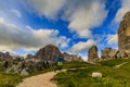 Tourist cycling in Cortina d`Ampezzo, stunning Cinque Torri and