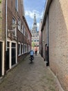 Tourist cycling towards the city hall of Franeker