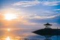 Tourist destination of Bali. The dawn of the sun and the gazebo at Sanur beach, Bali, Indonesia. Beautiful natural wallpaper Royalty Free Stock Photo