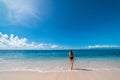 Tourist destination-Bali, Indonesia. A young tourist girl walks on an empty beach on the island of Bali. A sexy girl in a black Royalty Free Stock Photo