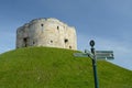 A tourist direction signpost by Cliffords's tower a stone monument in York UK