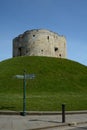 A tourist direction signpost by Cliffords's tower a stone monument in York UK