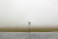 Tourist direction signs signpost in a foggy day Royalty Free Stock Photo