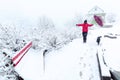 Tourist and a dog enjoy snowfall at Tosh village in Himachal pradesh, India